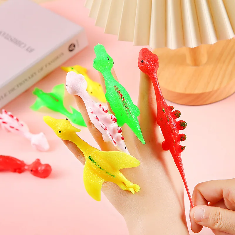 

24PCS Finger Dinosaur Sling Shots Catapult Toys Party Goodie Gift Bag Stuffer Fillers Birthday Halloween Party Favors Xmas Gifts