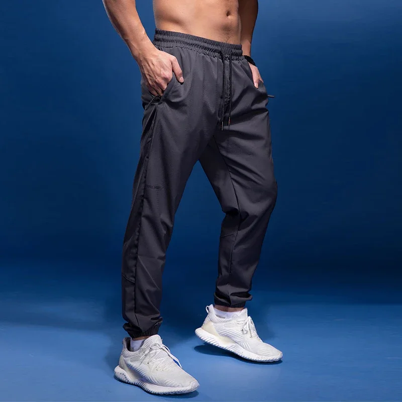 กางเกงกีฬากางเกงกางเกงวิ่งสำหรับผู้ชายมีกระเป๋าซิปใหม่สำหรับการฝึกซ้อมกางเกงกีฬากางเกงฟิตเนส