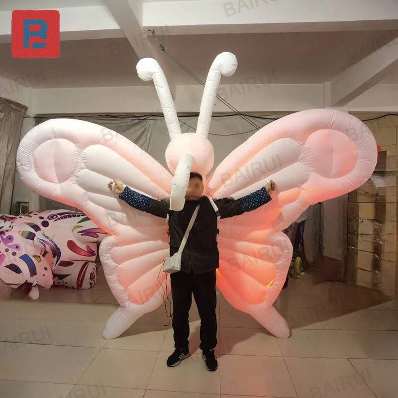Inflatable butterflies, festive performance dance parade, walking in white butterfly inflatable wings costumes