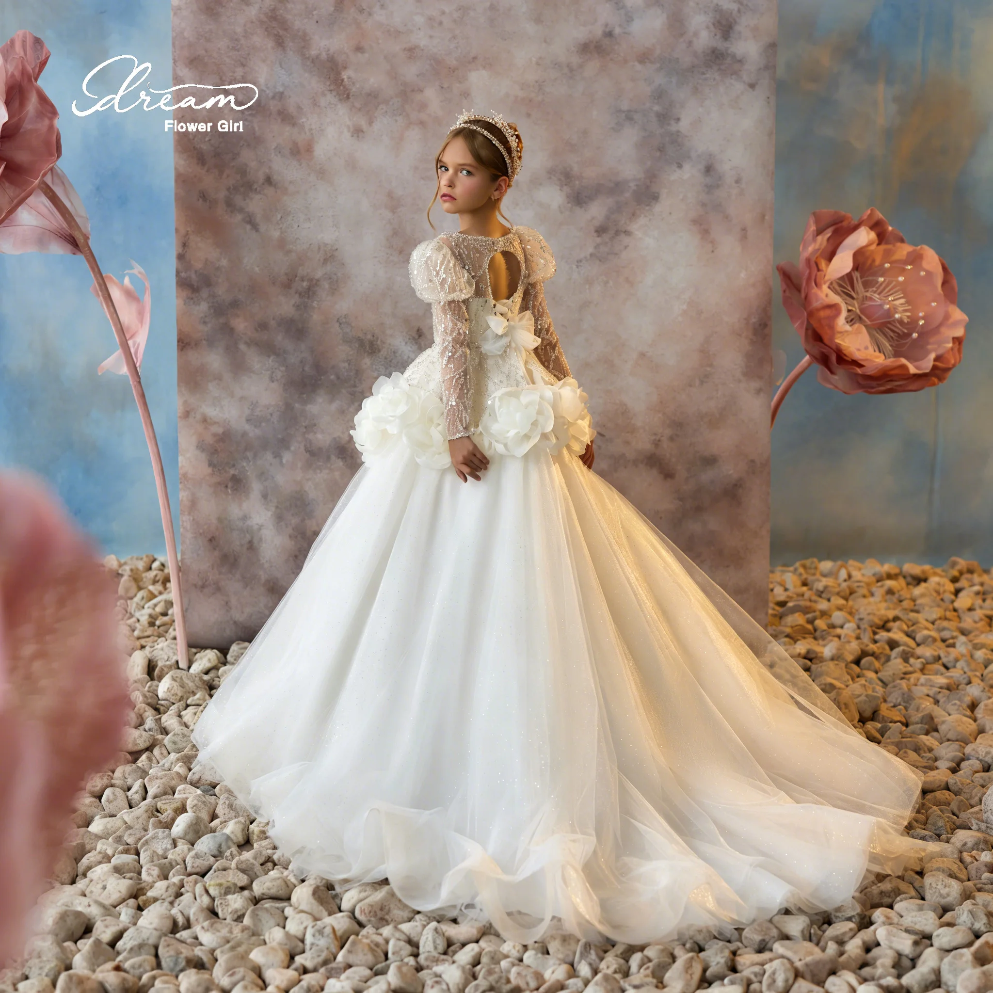 A beautiful backless, full-skirted evening dress with floor-length hem, featuring lace, sequins, strap bows and flower designs.