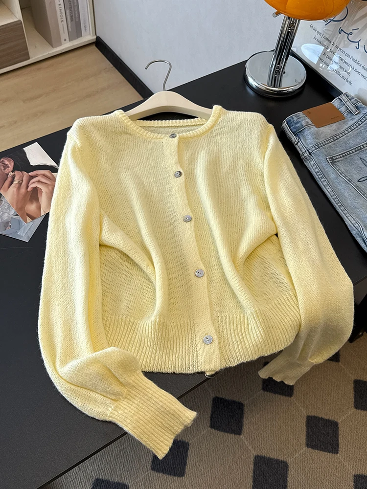 

An elegant, loose-fitting, lightweight crew-neck cardigan, perfect for spring and fall—whether for commuting, vacations