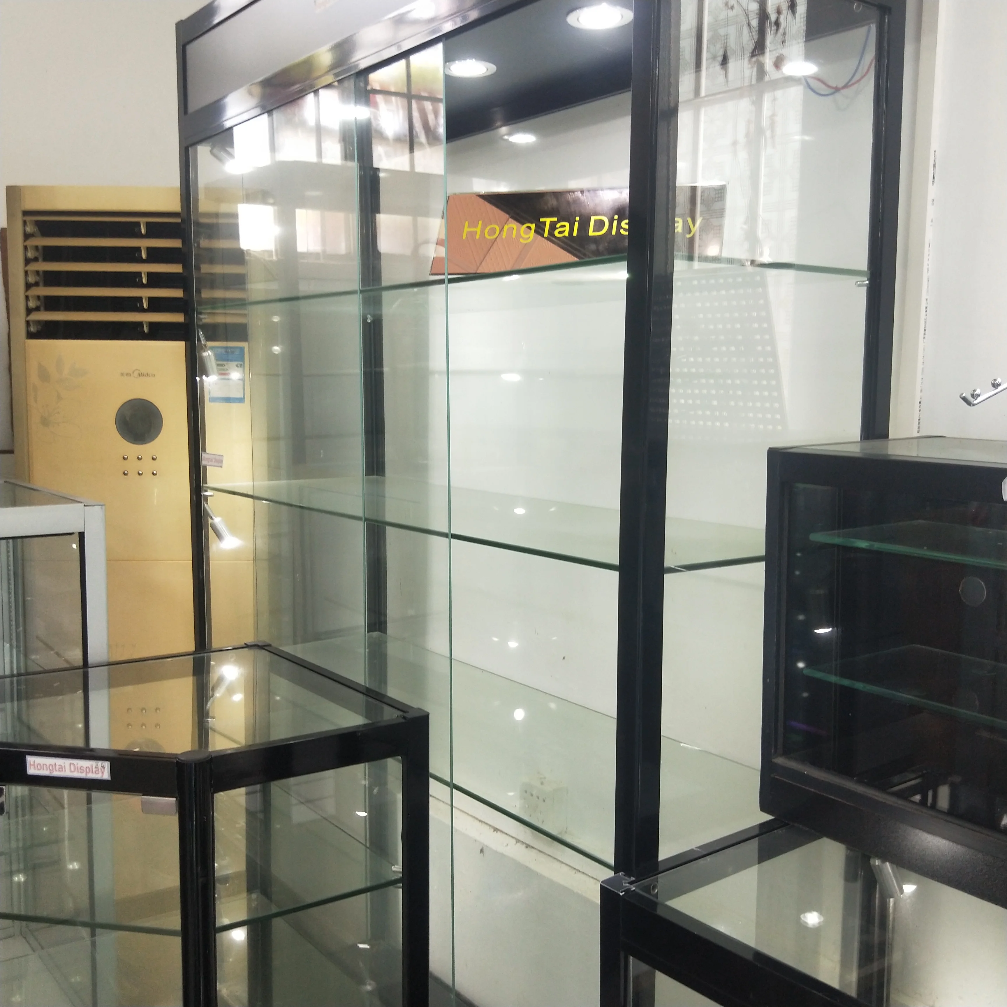 Custom.Hot Selling High End Tempered Glass Wall Display Cabinet With Led Lighting Shopping Mall Display Tall Cabinet