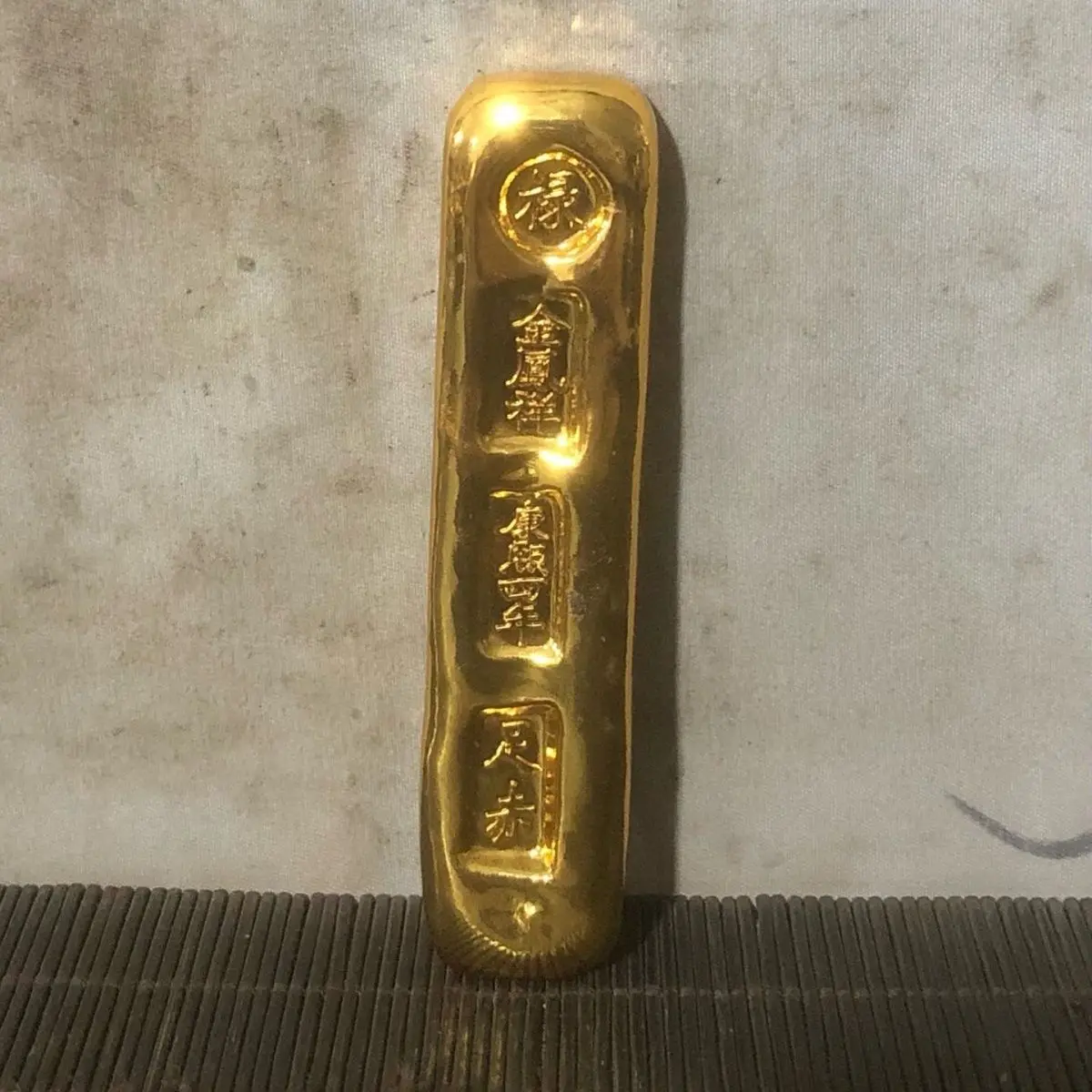 Vintage coins with solid gold bars and the character 'Lu' in the fourth year of the Kangxi reign off Qing Dynasty