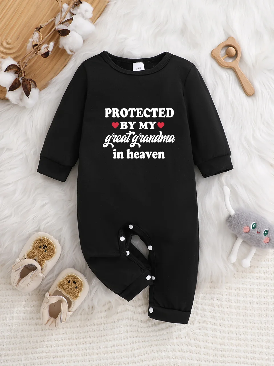 A baby long-sleeved onesie with interesting letter prints. It features a buttoned design for easy putting on and taking off, and