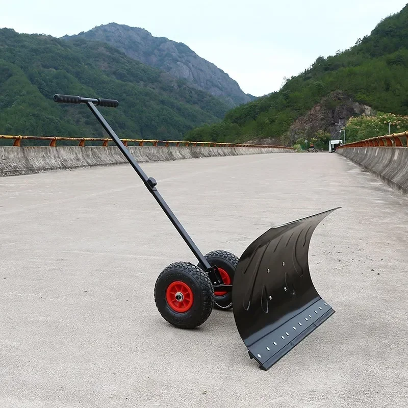 Manual snow shovel with wheels