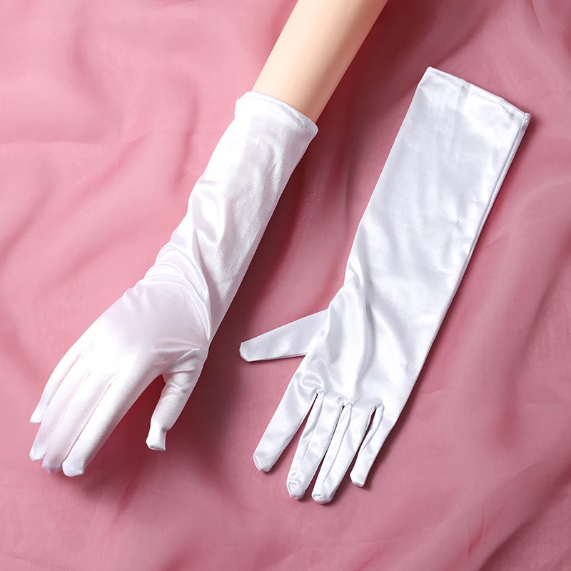 The bride's accessory is a pair of white minimalist split finger mid length gloves suitable for women's wedding parties