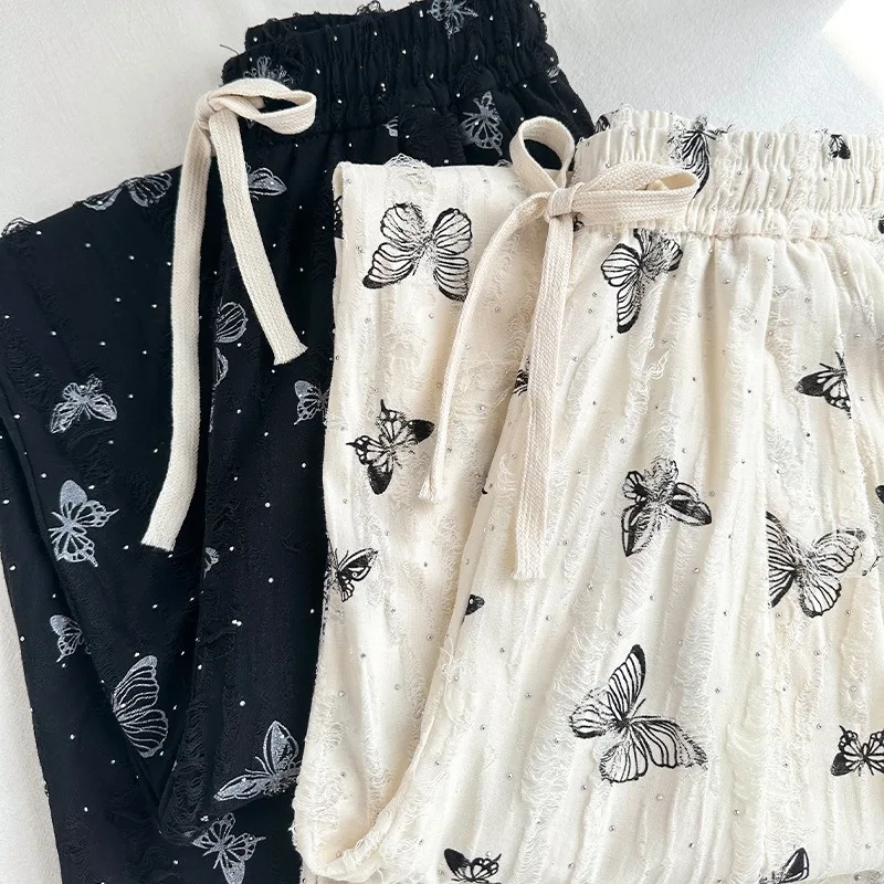 Nuovi pantaloni a gamba larga a farfalla in stile cinese Pantaloni a gamba dritta bianchi larghi e pigri a vita alta di nuovo stile estivo femminile con fori