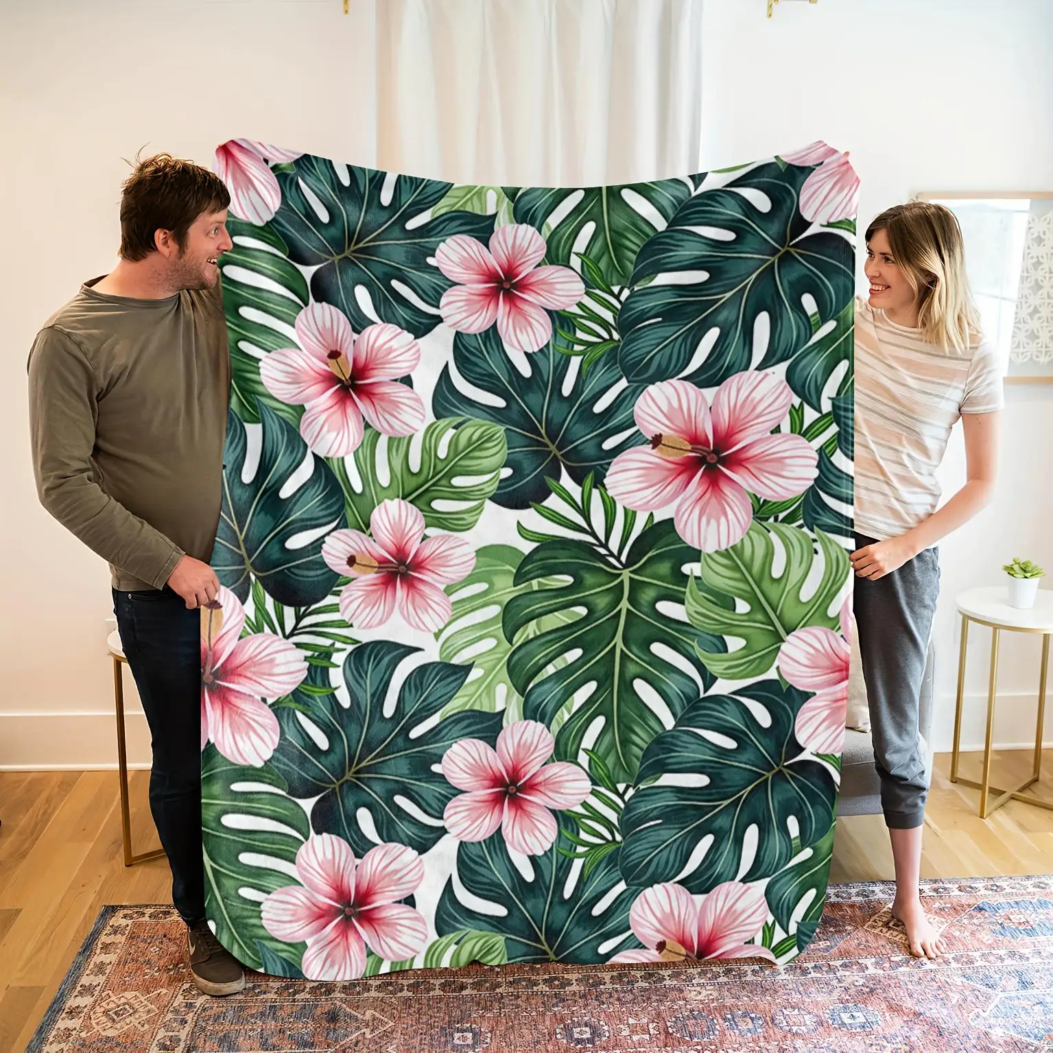 Pink hibiscus and green leaf pattern blanket, polyester fabric, machine washable, suitable for bedroom and living room décor.