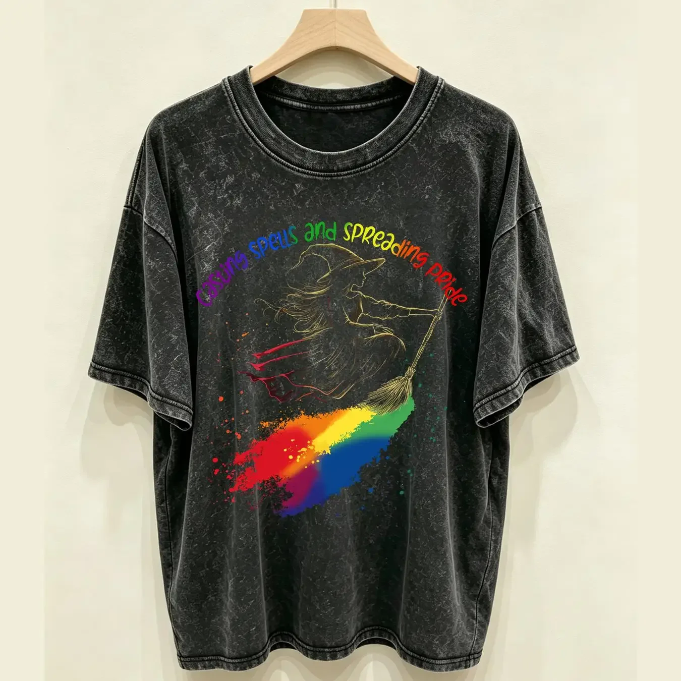 washed T Shirt Pride Halloween Cute Witch on Broom with LGBTQ Rainbow Black Bella Canvas 3001 Casting Spells and Spreading