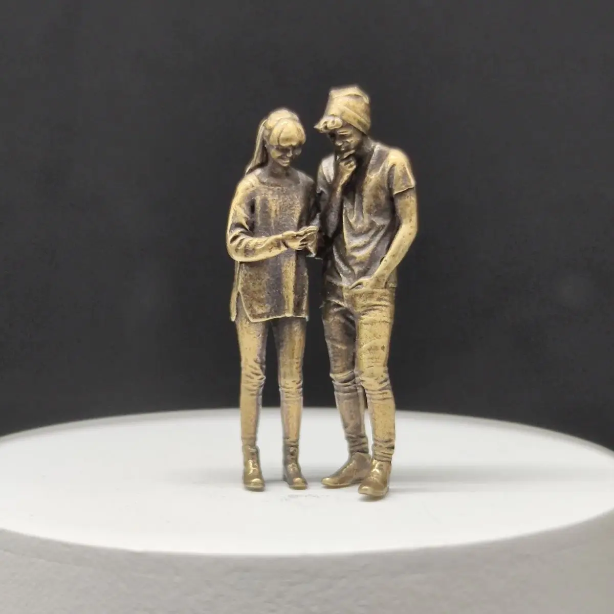 Brass miniature figurines 1/64 scale car model scene figures macro photography modern characters couple looking at phone