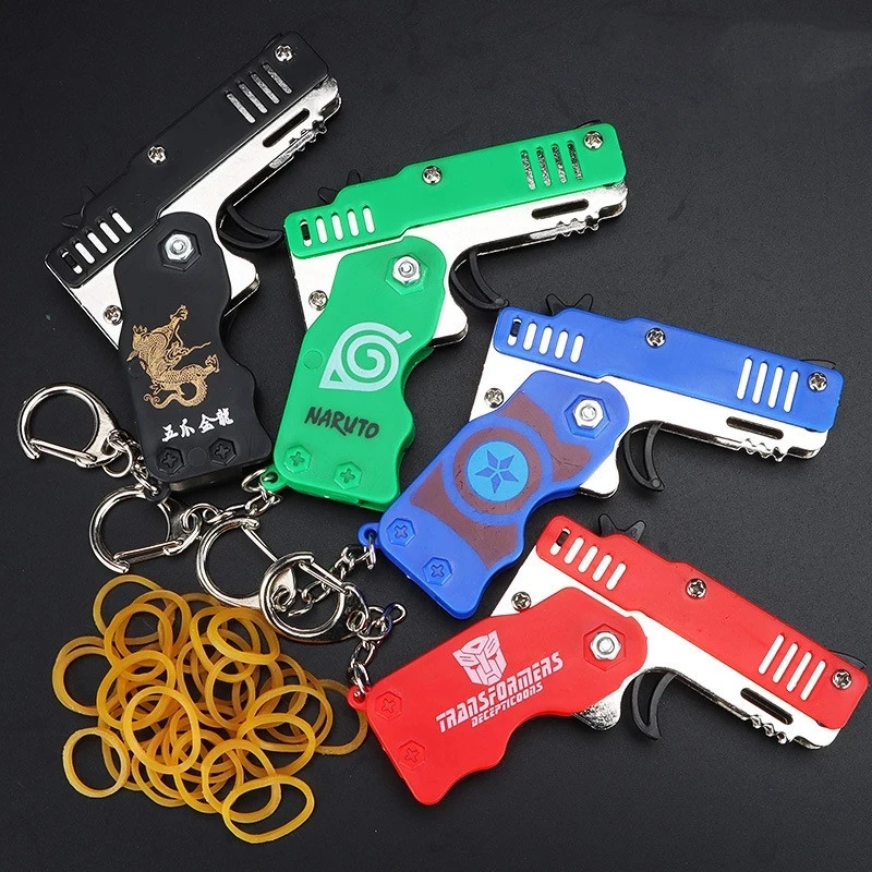 1PCS Mini Keychain Pistole Gummiband Pistole Spielzeug Schießen Pistole Legierung Kid Party Im Freien Klapp Metall Pistole Geschenke Freund spielzeug geschenk