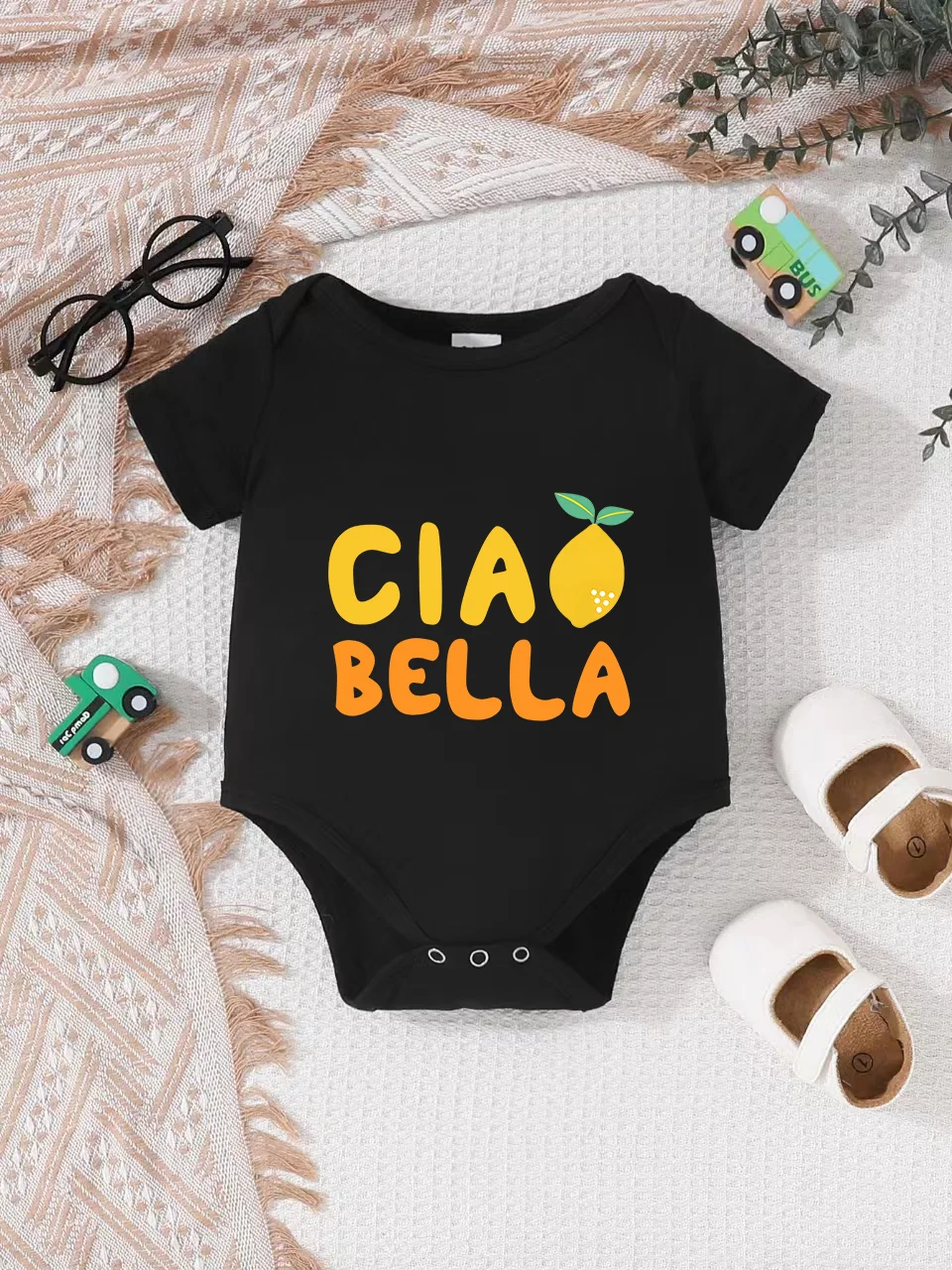 Playful letter-printed baby short-sleeve triangle bodysuit. Button closure for easy dressing