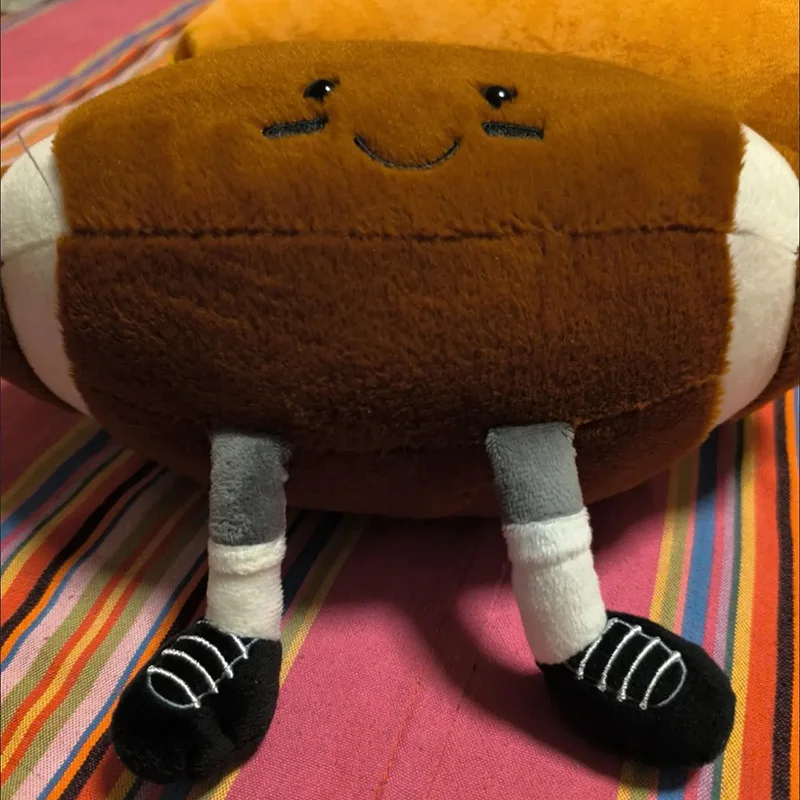 Image of Niedliches anthropomorphes, lächelndes Plüschtier, weicher, gefüllter Rugbyball-Plüsch mit Cartoon-Beinen, Komfort-Sport-Deko-Geschenk für Fans