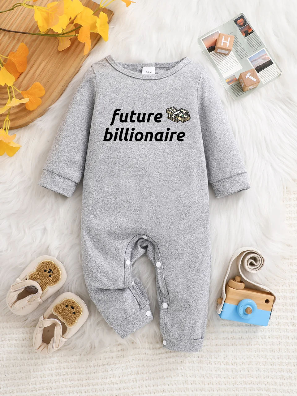 A baby long-sleeved onesie with interesting letter prints. It features a buttoned design for easy putting on and taking off