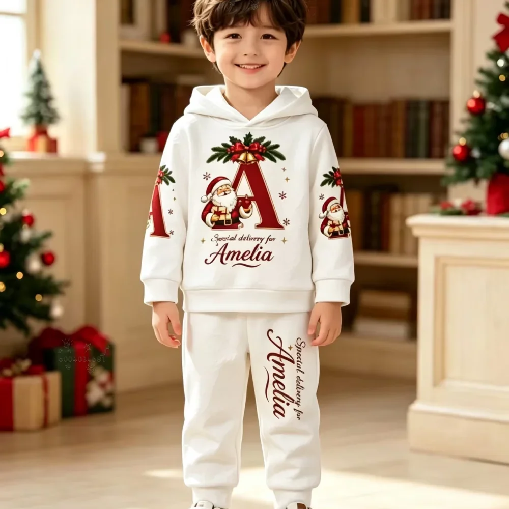 A casual two-piece Christmas outfit for children,featuring a hoodie and sweatpantsadorned withlettering andSanta Claus graphics.