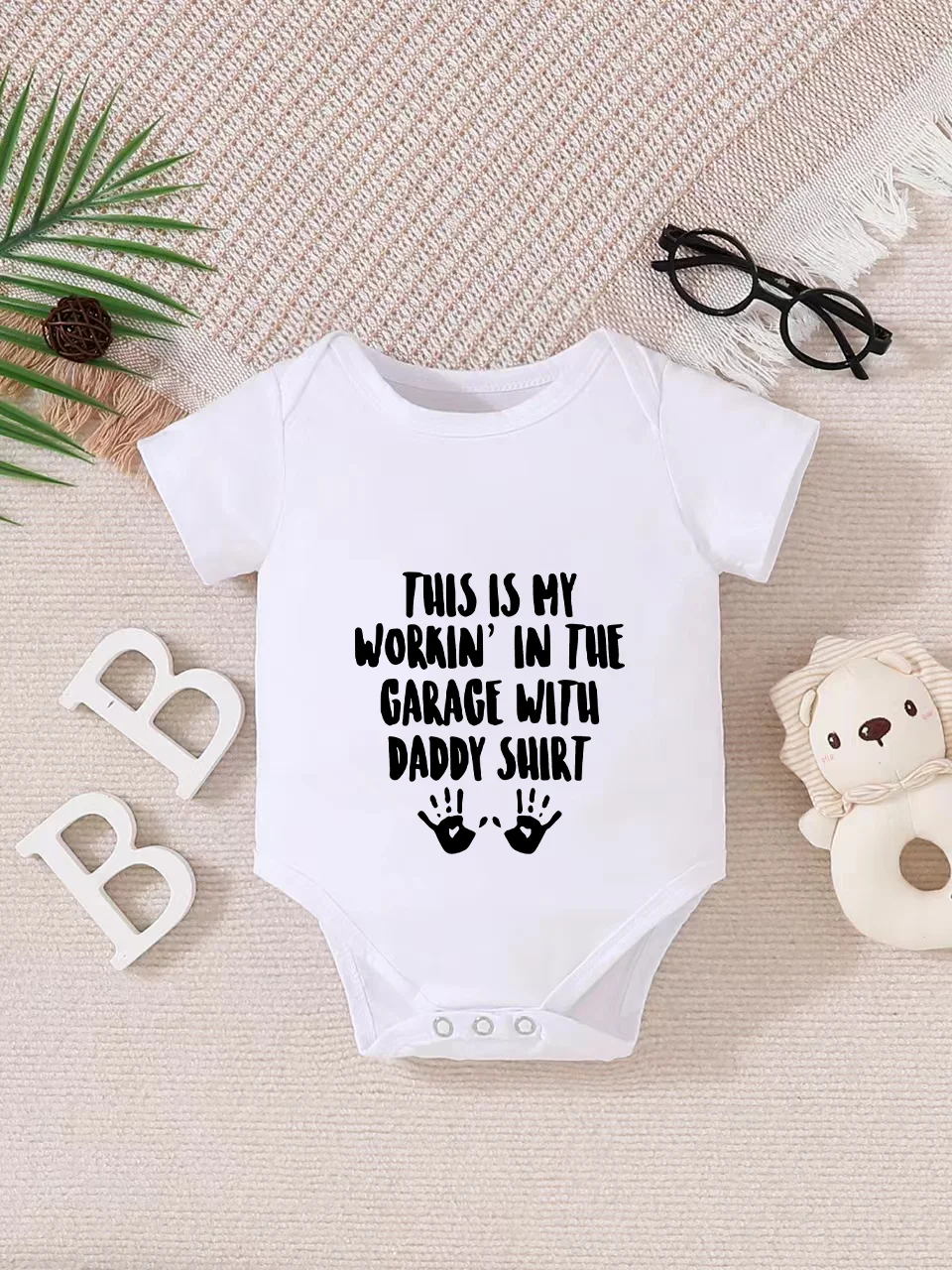 Playful letter-printed baby short-sleeve triangle bodysuit. Button closure for easy dressing, machine washable