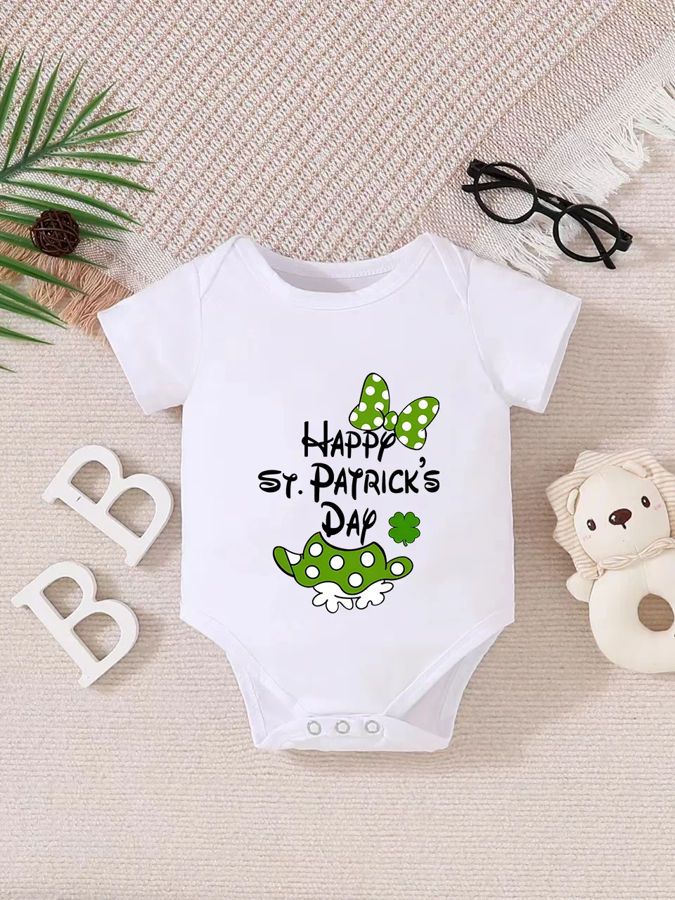 Playful letter-printed baby short-sleeve triangle bodysuit. Button closure for easy dressing, machine washable