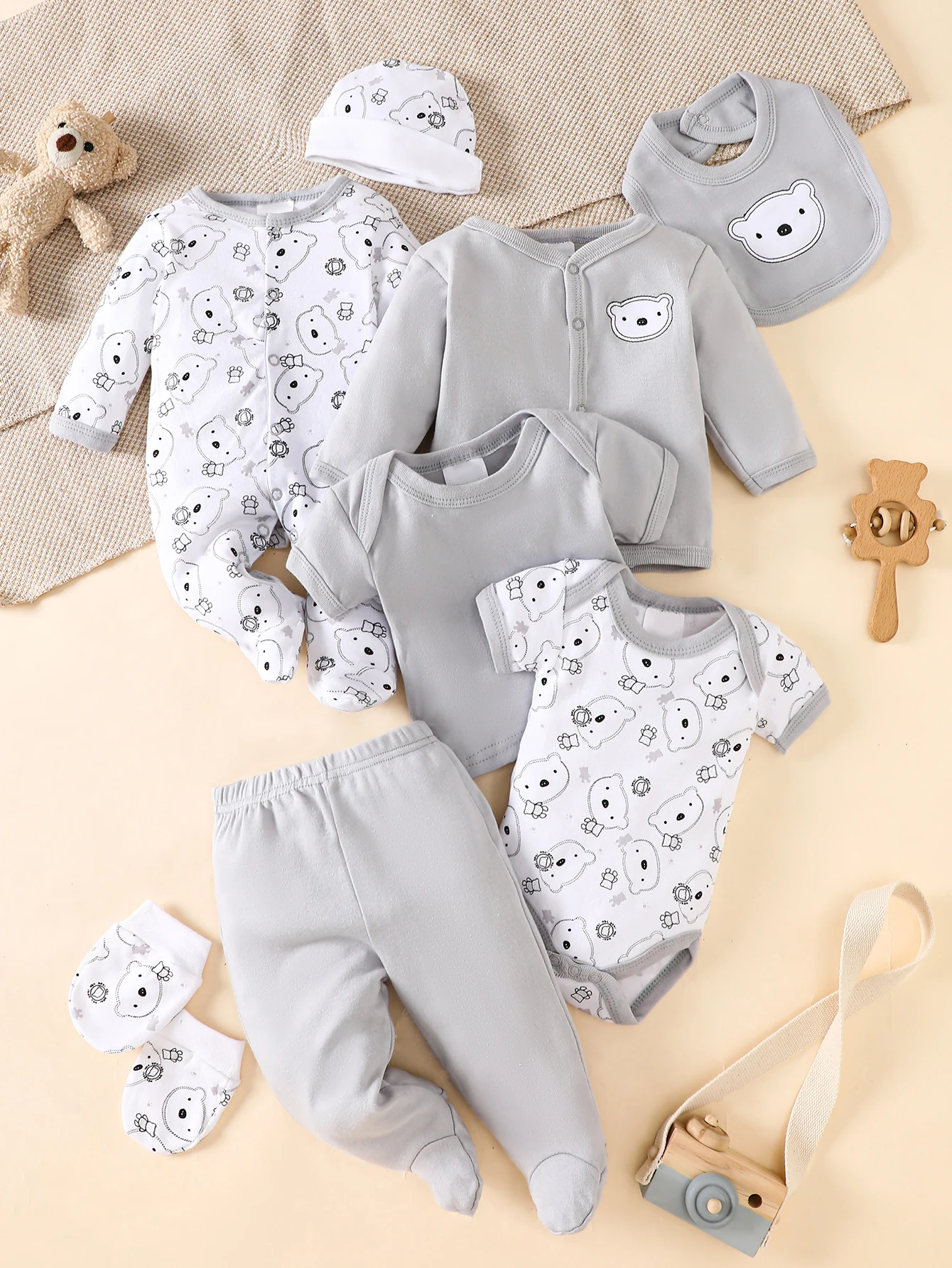 his 8-piece unisex newborn layette set fits boys and girls aged 0-9 months, with lovely grey bear prints.