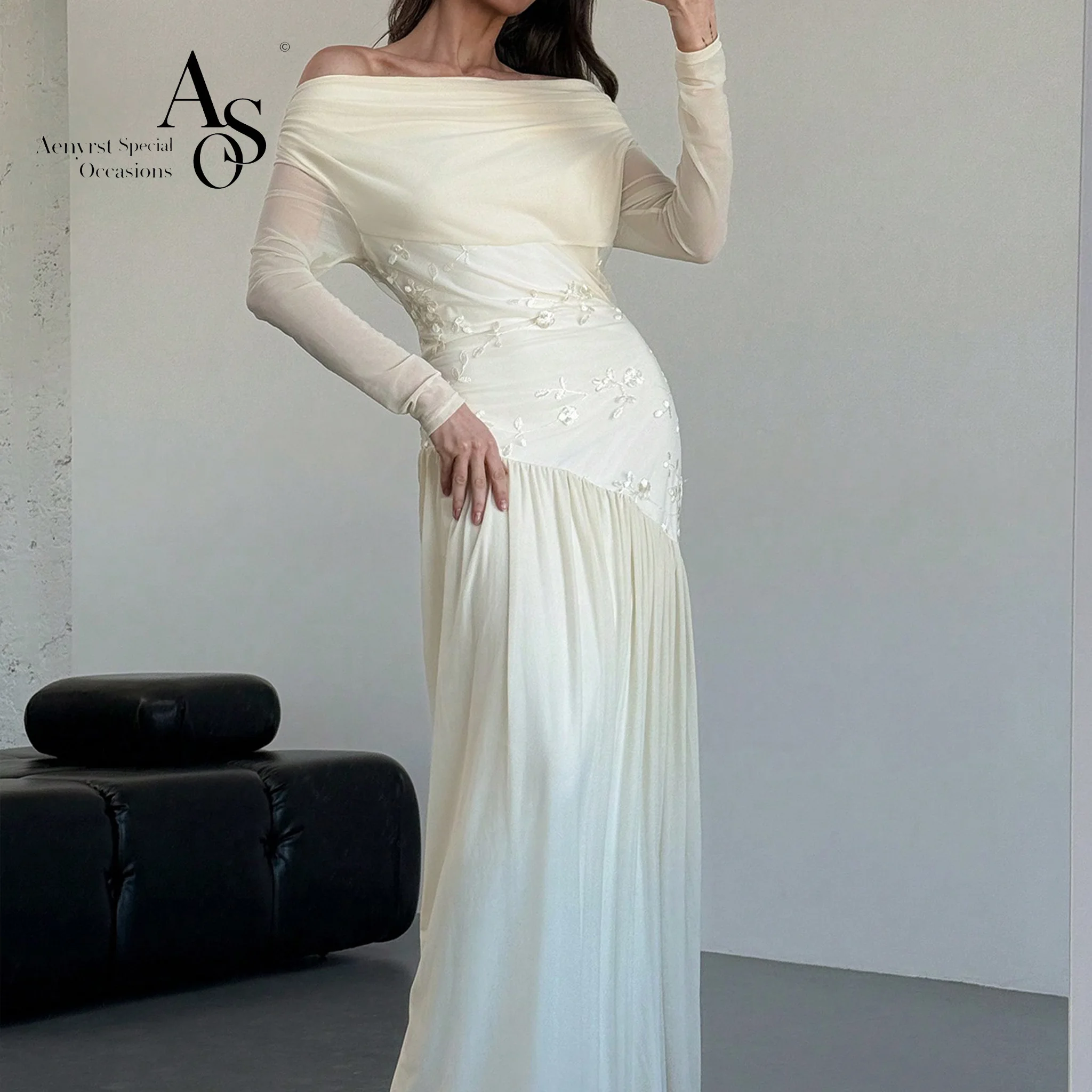Ivory white chiffon off-the-shoulder long-sleeve formal gown featuring draping embroidery and an open back