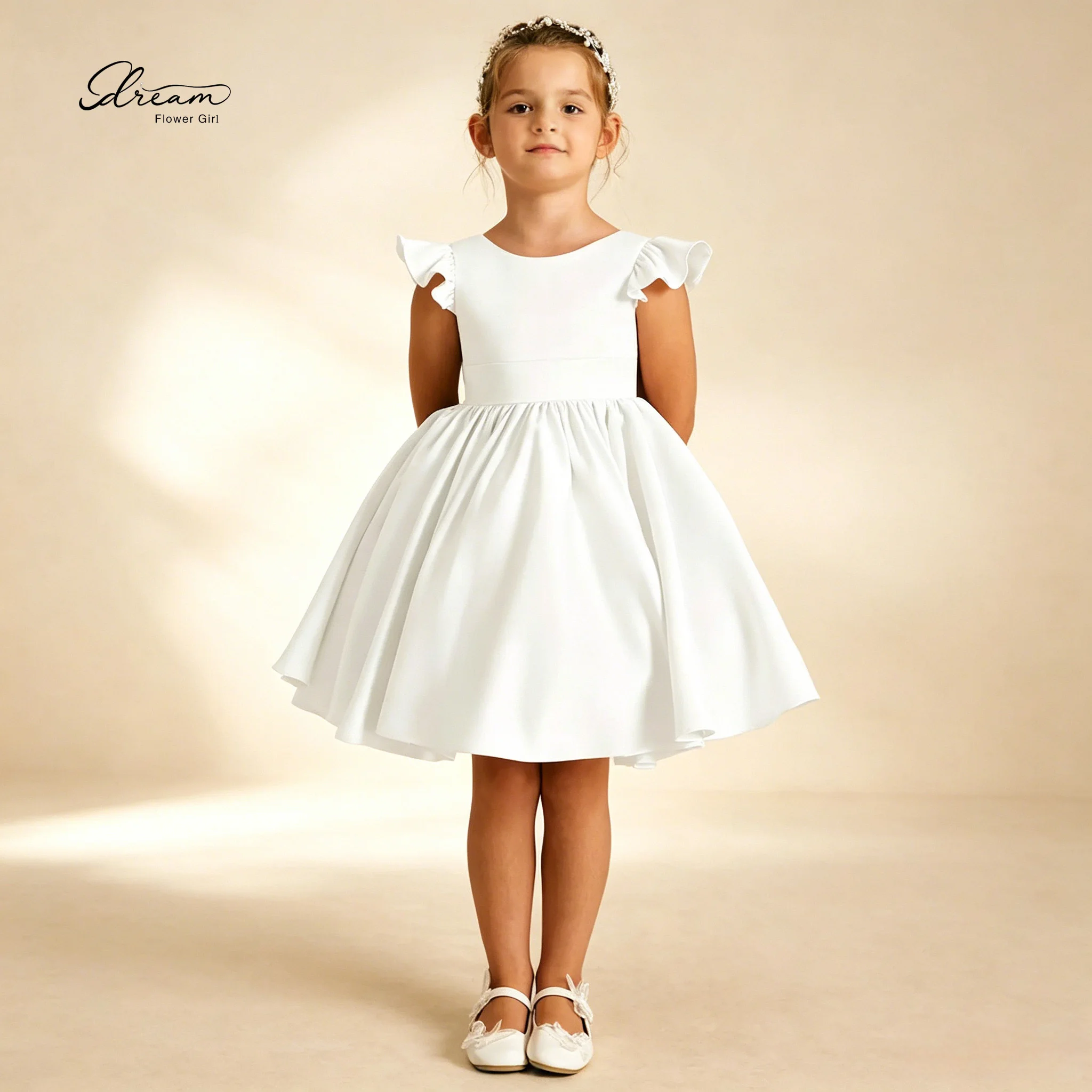 

An elegant white chiffon sleeveless knee-length party dress for children featuring ruffled sleeves and a cinched waist design.