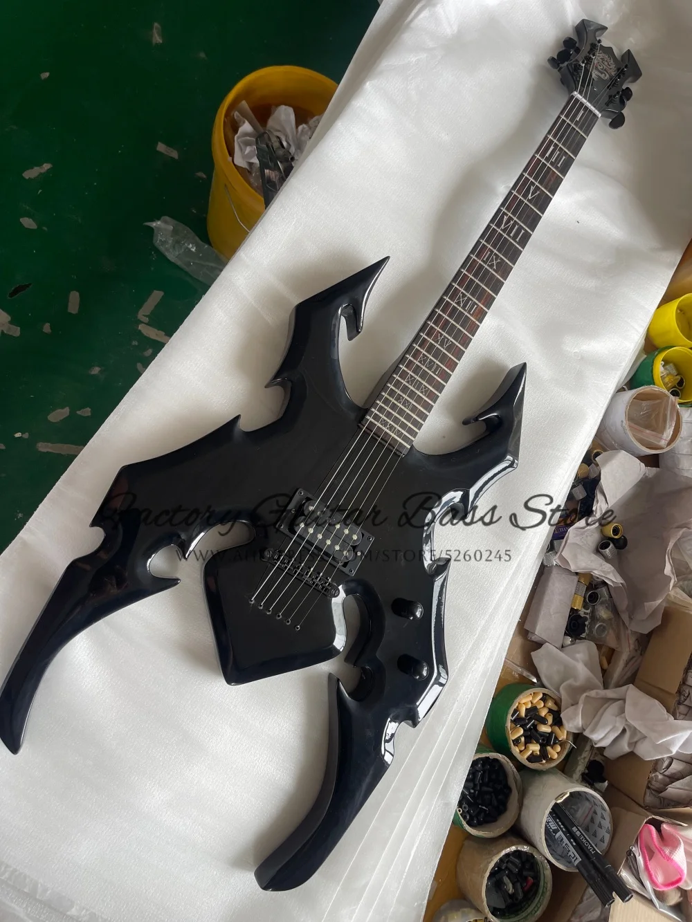 Custom black guitar, spider guitar, Roman numeral inlaid fingerboard, fixed bridge, H pickups, black tuners