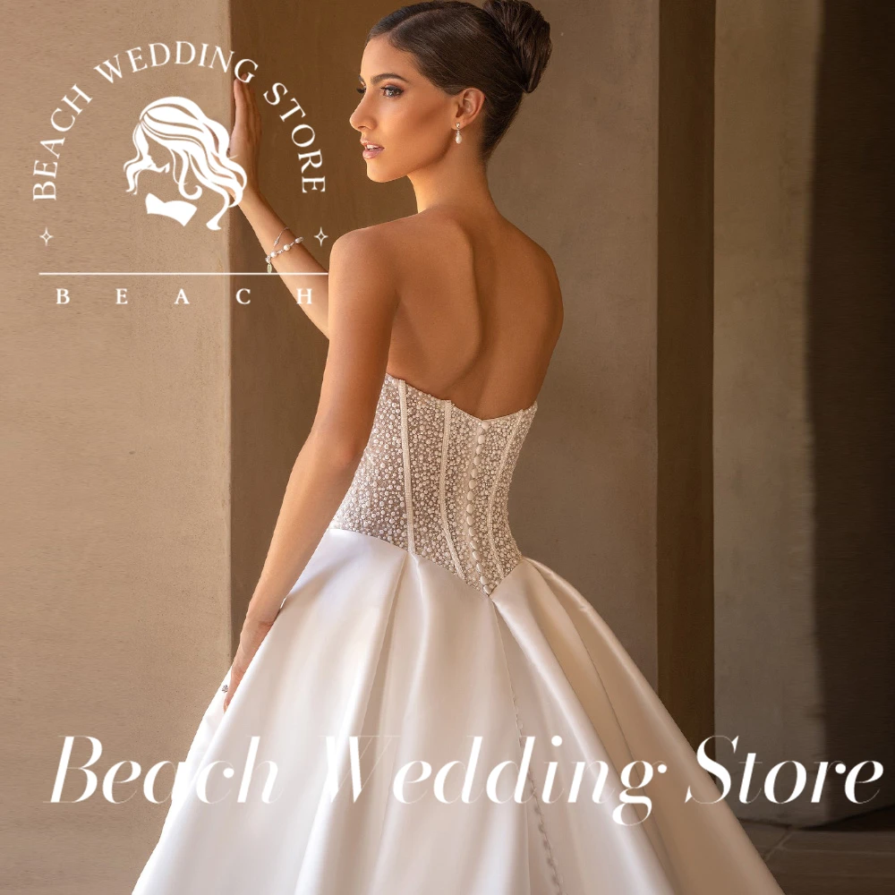 Beach Wedding Store Customized Strapless Ball Gown Wedding Dress with Embellished Bodice Sheer Lace Detailing and High Slit