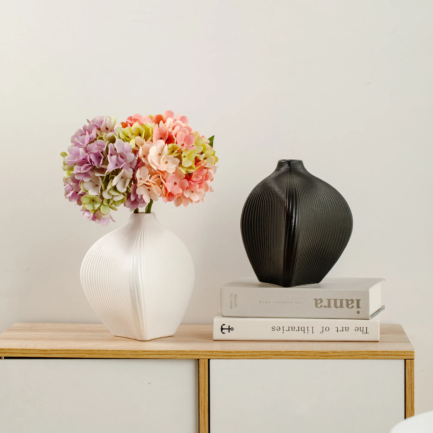 

Ceramic vase with simple white vertical stripes, featuring a Nordic style, suitable for home decoration as a flower container.