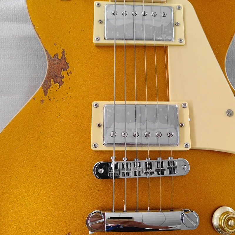 Gold vintage-style electric guitar with a cream pickguard and gold knobs, dual humbuckers, fixed bridge, perfect for band stage performances. Ships from local warehouse, rock style, right-handed play, 22 frets, 6 strings.