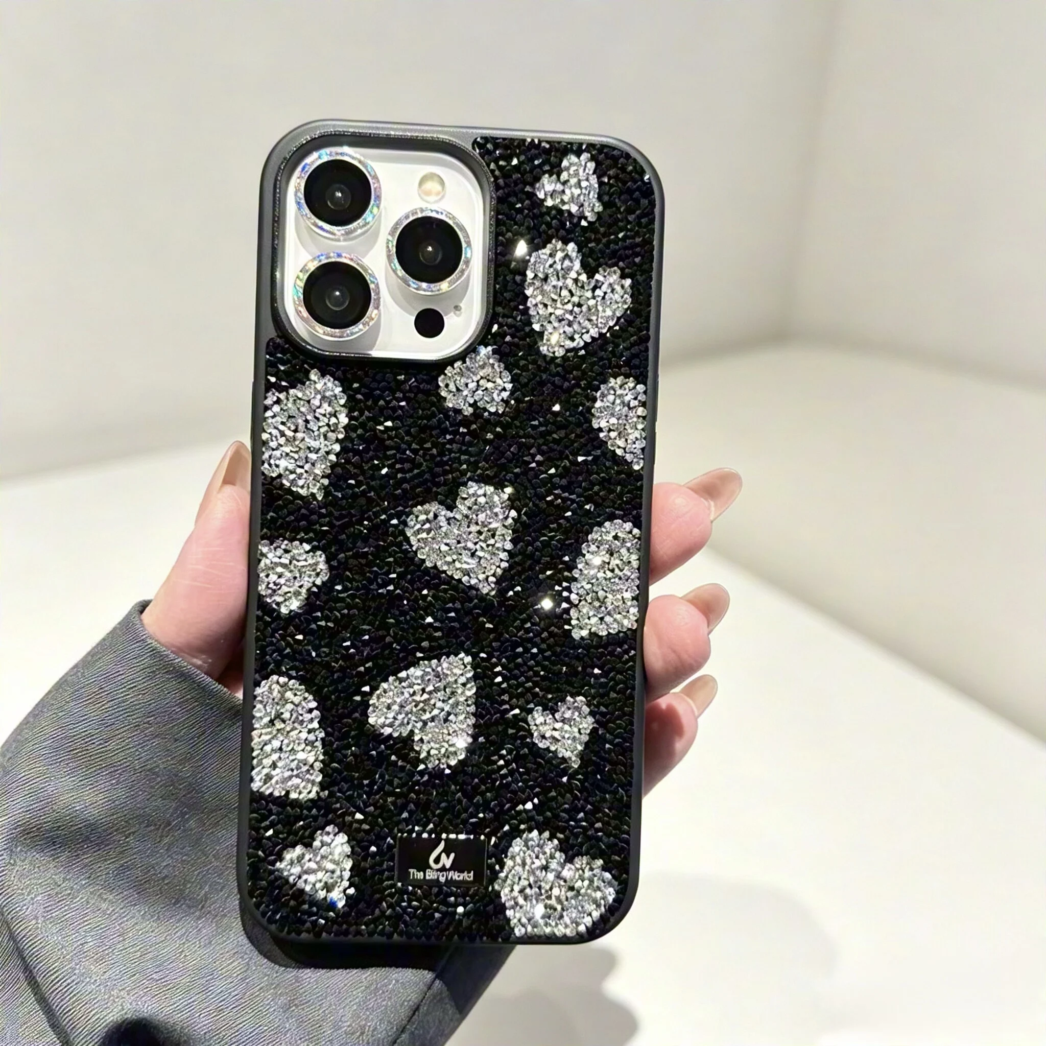 Luxury-lite water droplet-shaped black phone case with love hearts, suitable for iPhone, with full silicone coating.