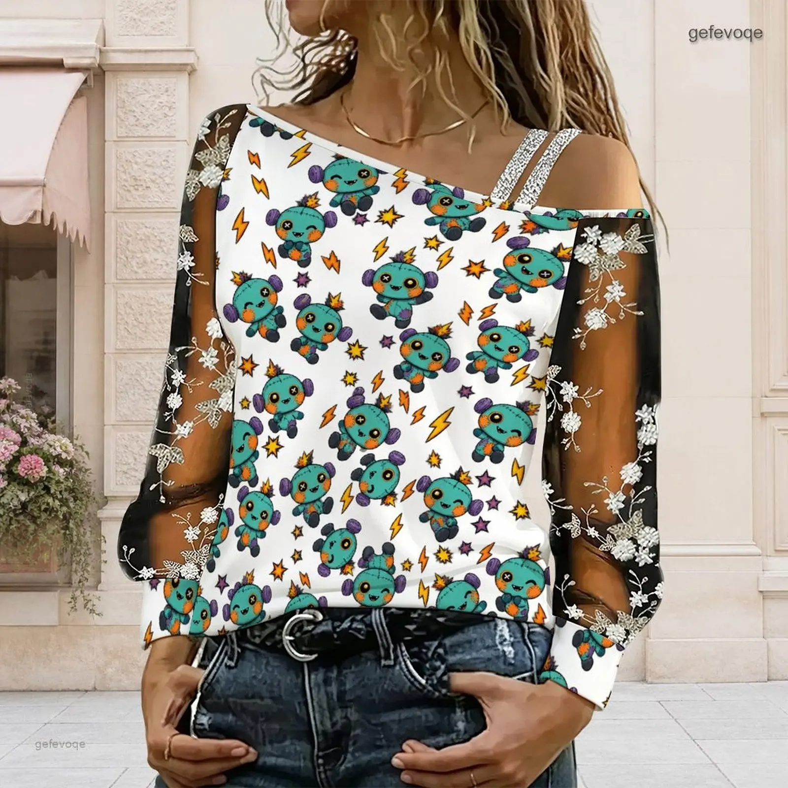 Women Cartoon Voodoo Doll Lightning Star Print Asymmetric Cold Shoulder Long Sleeve Embroidered Sheer Top