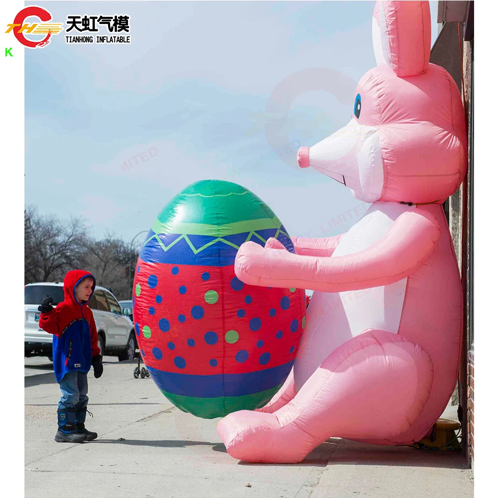 กระต่ายเป่าลมอวยพรเทศกาลอีสเตอร์ถือไข่สำหรับโฆษณา โมเดลกระต่ายเป่าลมขนาดใหญ่สำหรับตกแต่งสนาม