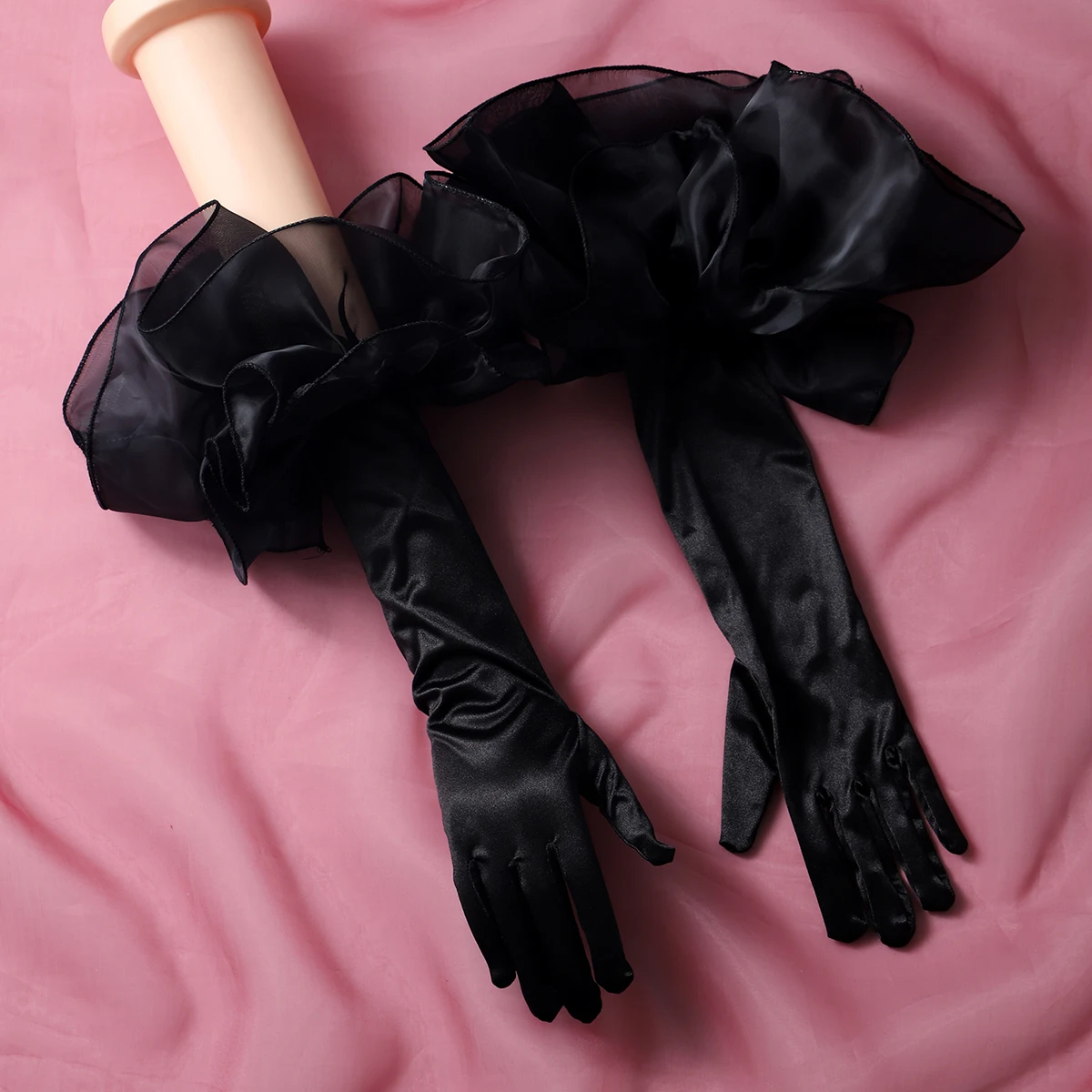 A pair of finger style elbow length bubble sleeve gloves, suitable as accessories for bride weddings or women's dances