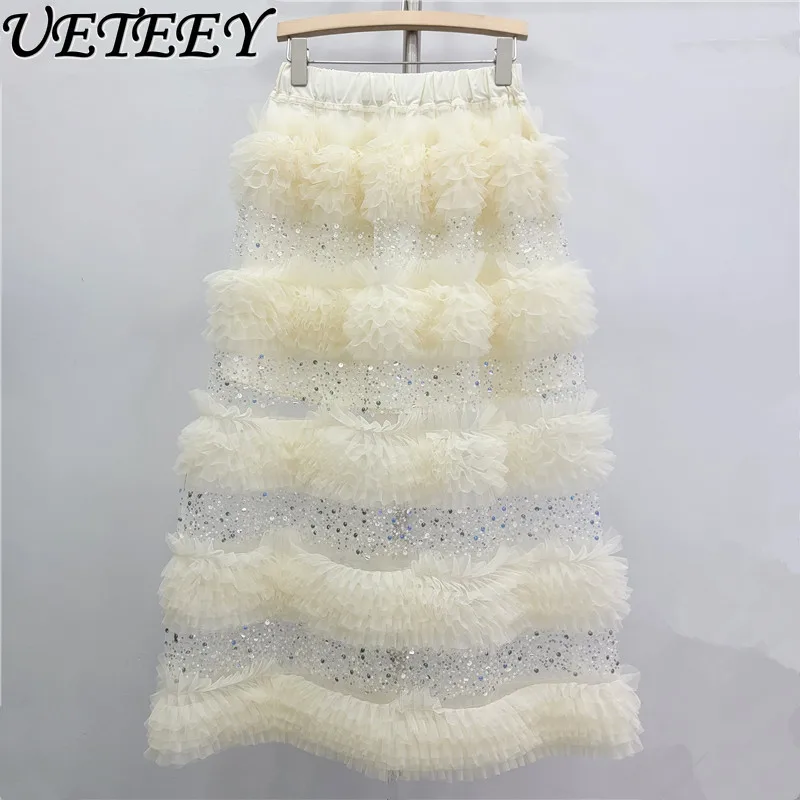 กระโปรงยาวทรงเค้กแต่งระบายผ้าทูลล์ประดับเลื่อมเอวสูงยางยืด สไตล์แฟชั่นใหม่รับฤดูใบไม้ผลิปี 2026 สีแอปริคอต ดีไซน์อเนกประสงค์สำหรับผู้หญิง