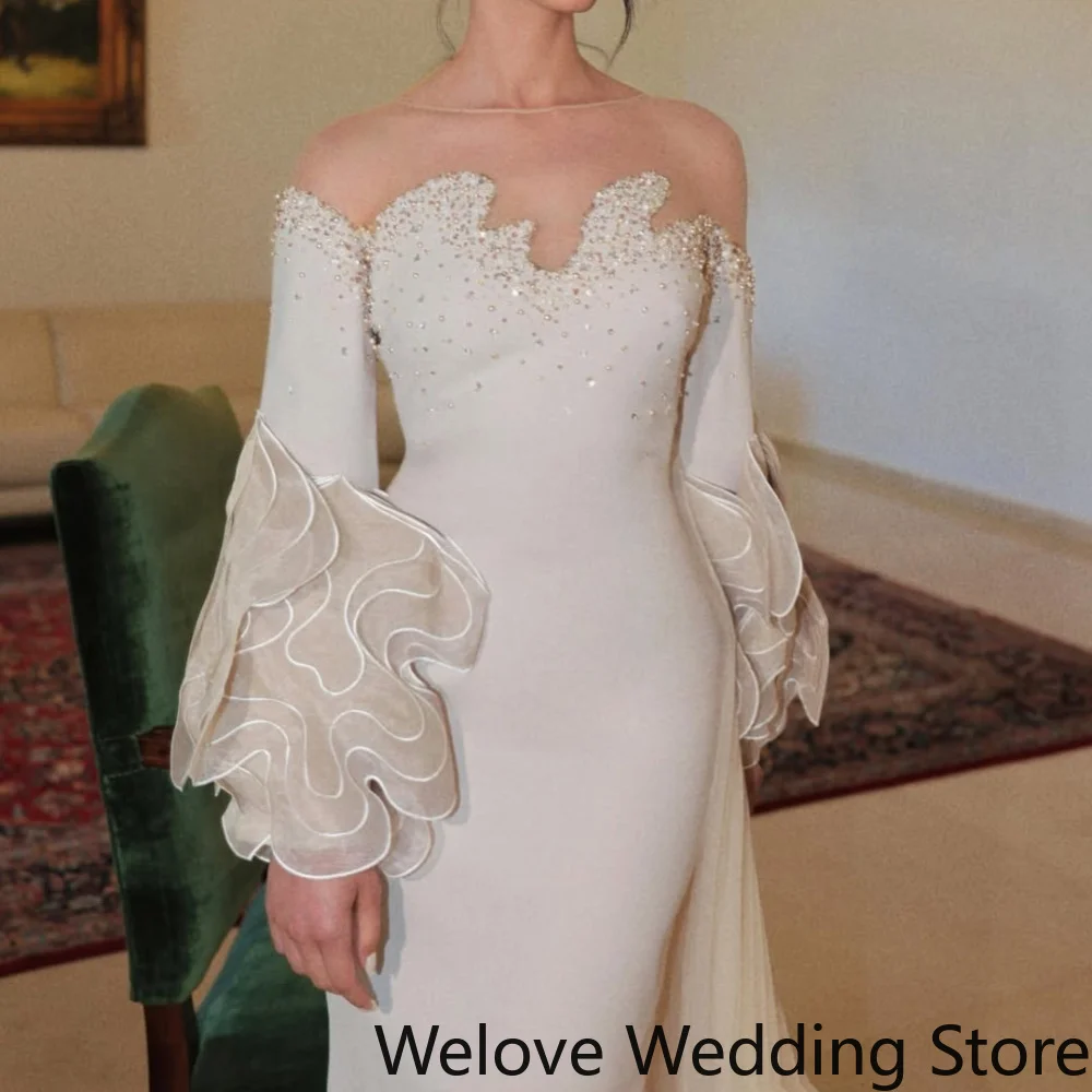 Mermaid Bridal Gown Featuring an Off-the-Shoulder Illusion Neckline Lace Embellished Bust Voluminous 3D Floral Long Sleeves