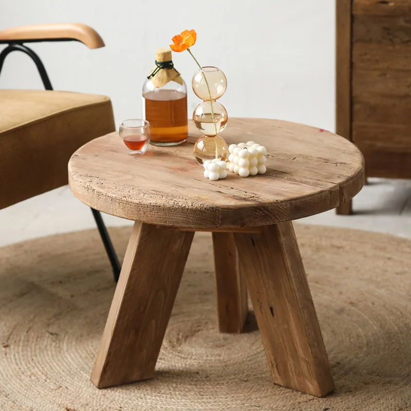 Wooden small round coffee table with a quiet breeze, old pine wood, round logs, creative retro design, and vintage home