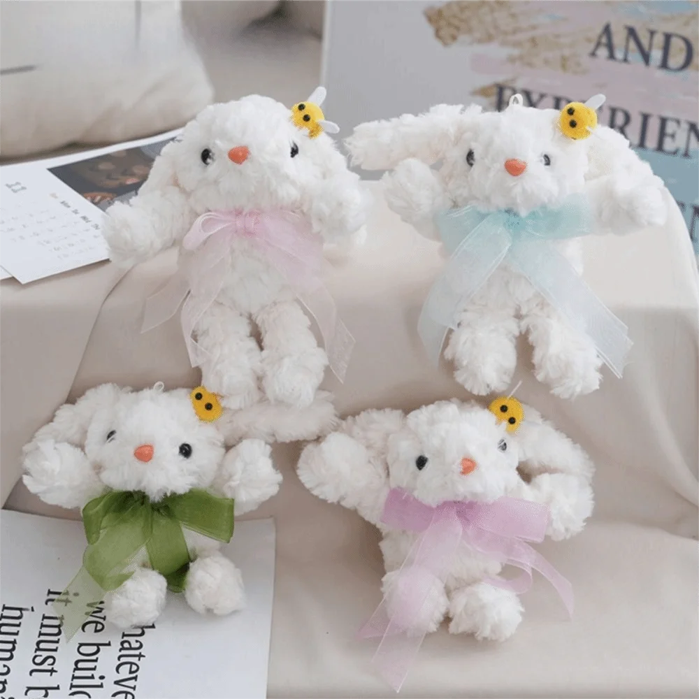 ตุ๊กตากระต่ายขนนุ่มแบบใหม่ กระเป๋าตุ๊กตาการ์ตูนผูกโบว์ ของเล่นตุ๊กตาแบบมีพวงกุญแจ ของขวัญ ห้อยตกแต่งหูห้อย