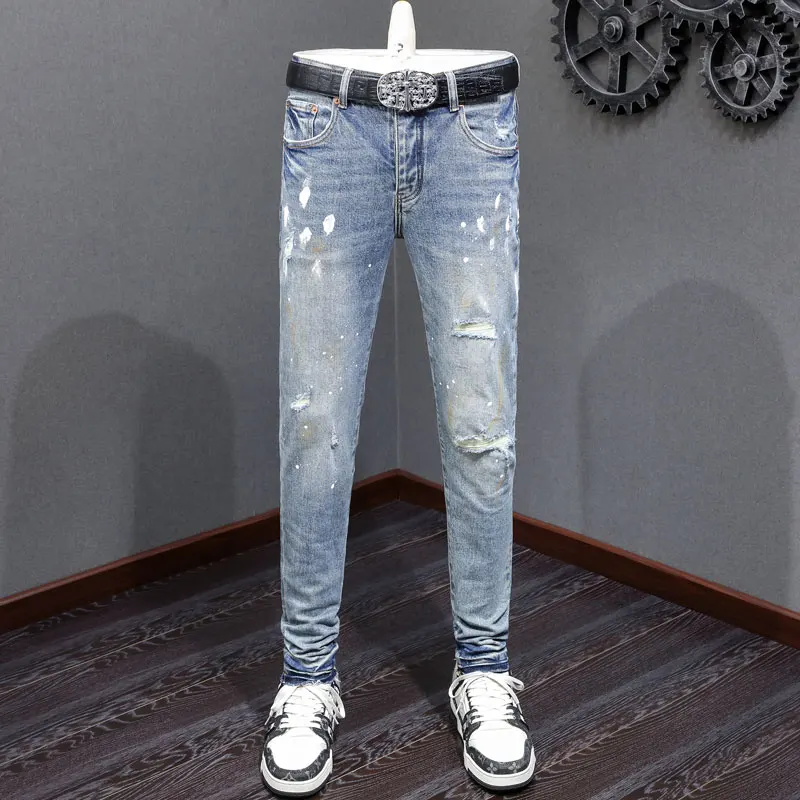 Fashionable new light blue men's jeans with painted perforations, patch buttons, high street trendy hip-hop brand, high-quality