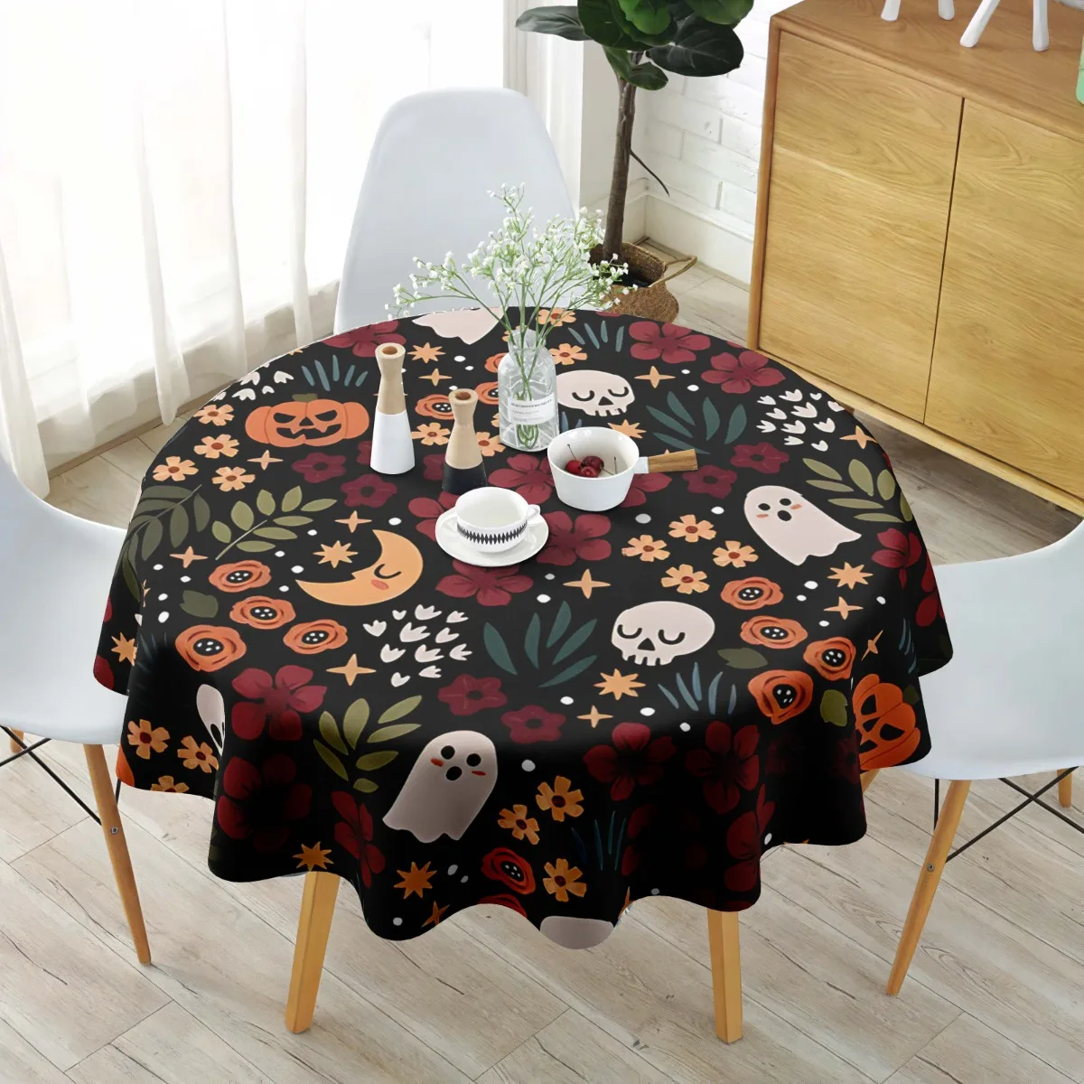 A round rectangular polyester tablecloth with a ghost pumpkin skull pattern printed on it.