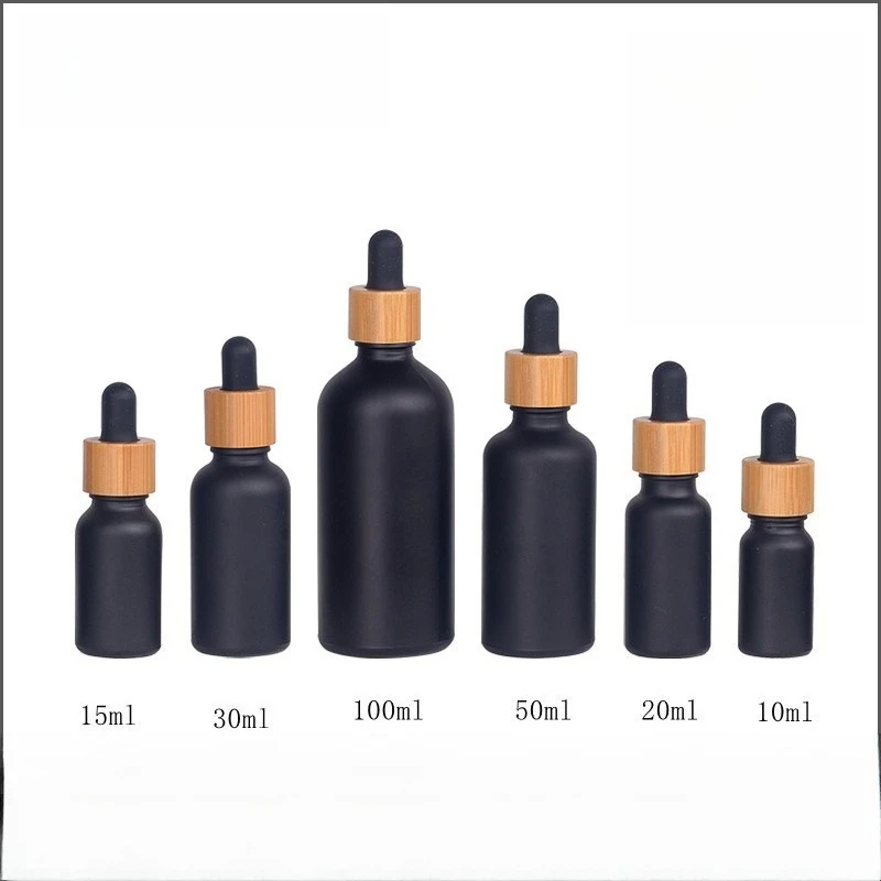 2/5/10 Uds 5/10/15/20/30/50/100ml botella de aceite esencial negro mate tapa cuentagotas de goma de madera de bambú botella cosmética de vidrio esmerilado