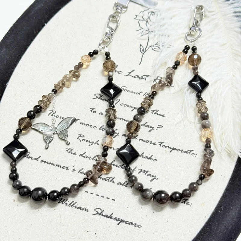 

Natural tea crystal gravel, silver obsidian cubes, black shell butterfly, handmade mobile phone and bag pendant design