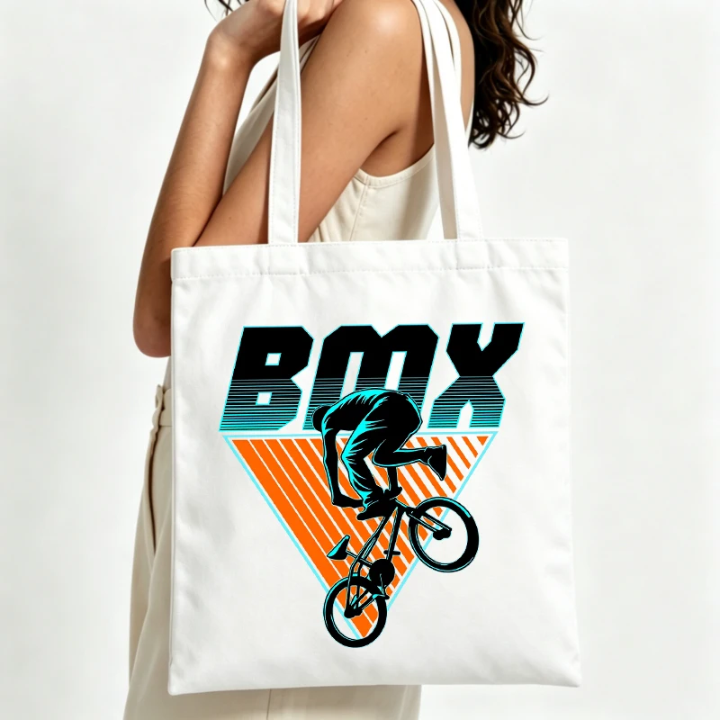 Women's BMX rider graphic canvas tote bag with retro typography, perfect for casual daily use and street-style outings