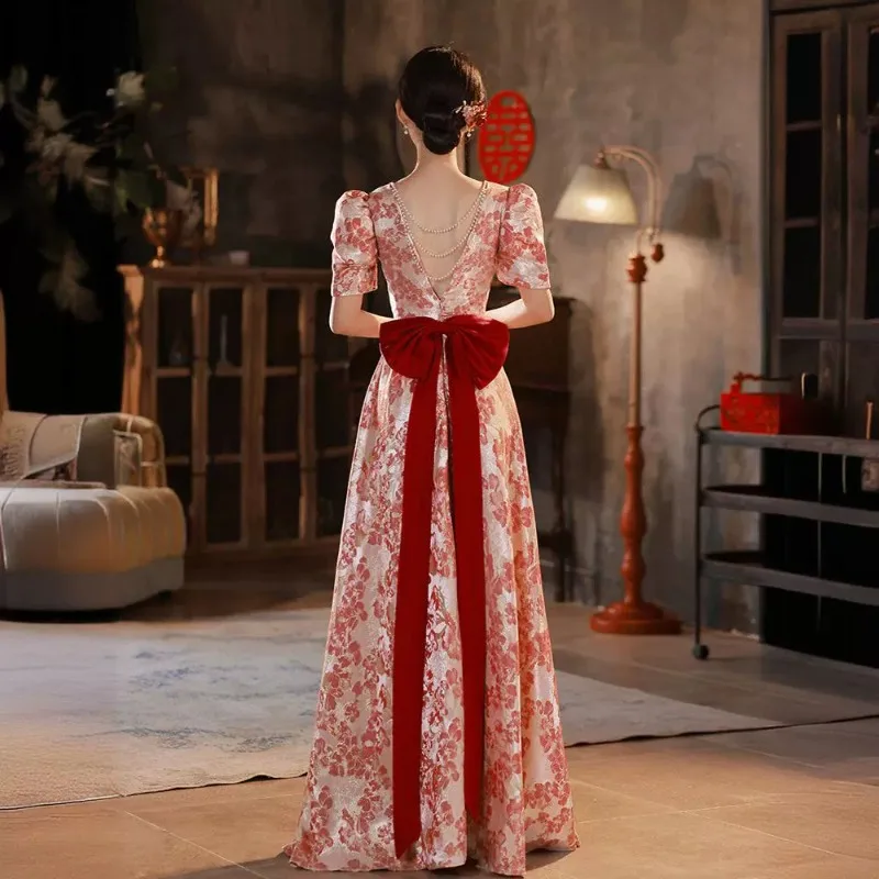 

2026 New Women's V-neck Wine Red Banquet Toast Evening Dress Fashionable Slim Fit Bareback Printed Bow Decoration Long Dress