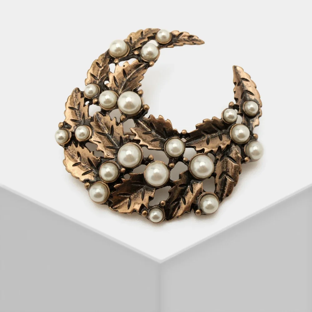 

AB/ Floral Plant Half-moon shape embellished with imitation pearl brooch for ladies.