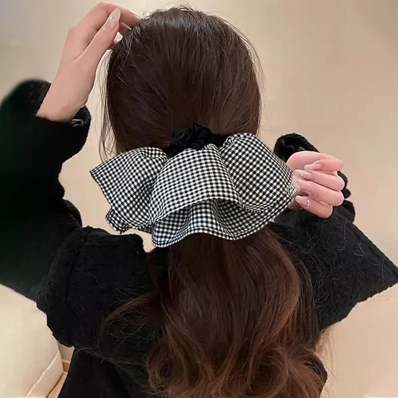 

French-style oversized checkered skirt with a big bow hair tie for women, stylish low ponytail hair rope