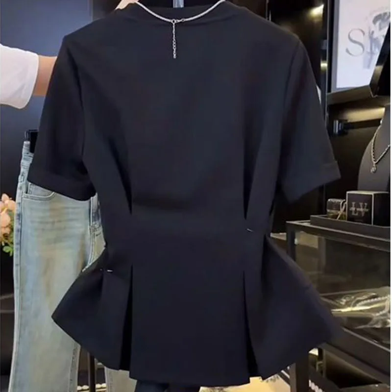 Black blouse female 2024 summer new irregular design slim Joker fake two-piece short-sleeved T-shirt with ruffled stitching.