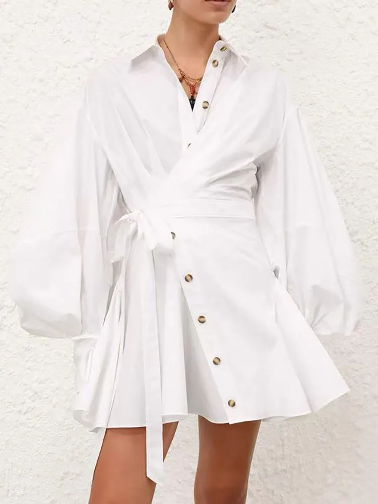 This autumn retro lapel lantern-sleeved shirt dress is designed with an irregular diagonal buckle and a cinched waist