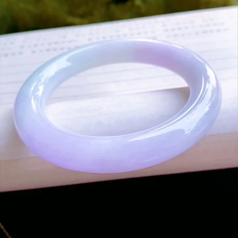 Natural old mine jadeite bracelet  featuring a vibrant green color  floral patterns  a violet hue  and a translucent  icy textur