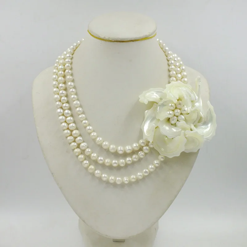 

The latest design.3 layers of 8MM grade A natural freshwater pearls.Shell flower necklace.Bride's wedding Jewelry