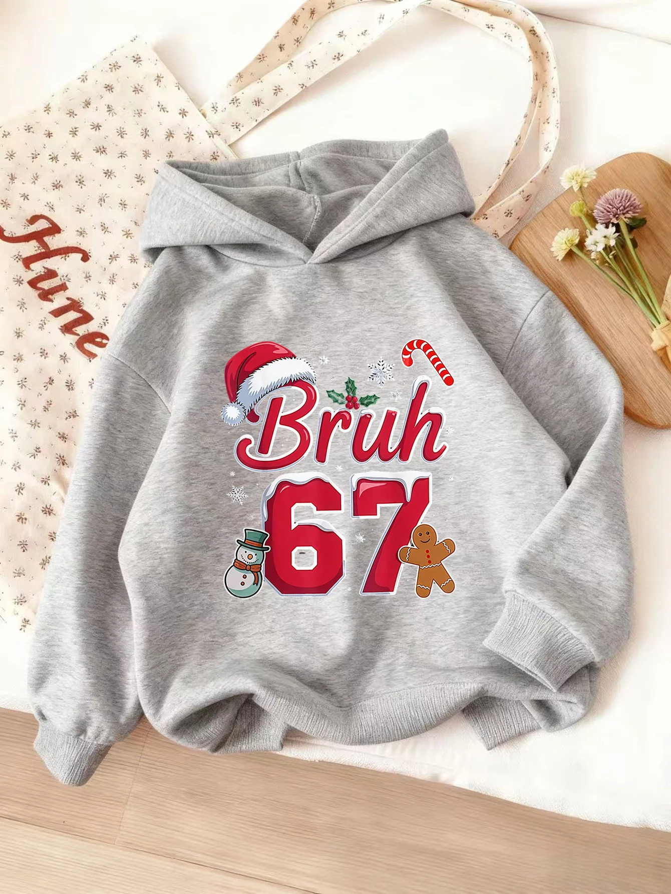 Girls' hooded sweatshirt with Christmas theme, featuring the number 60seven and gingerbread man design. Unisex holiday gift.