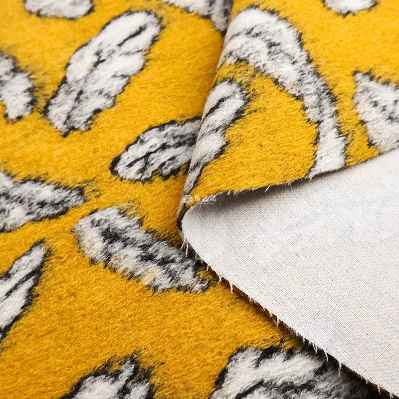 The fabric for coat is made of multi-colored orange yellow and blue leaf mille-feuille real wool velvet